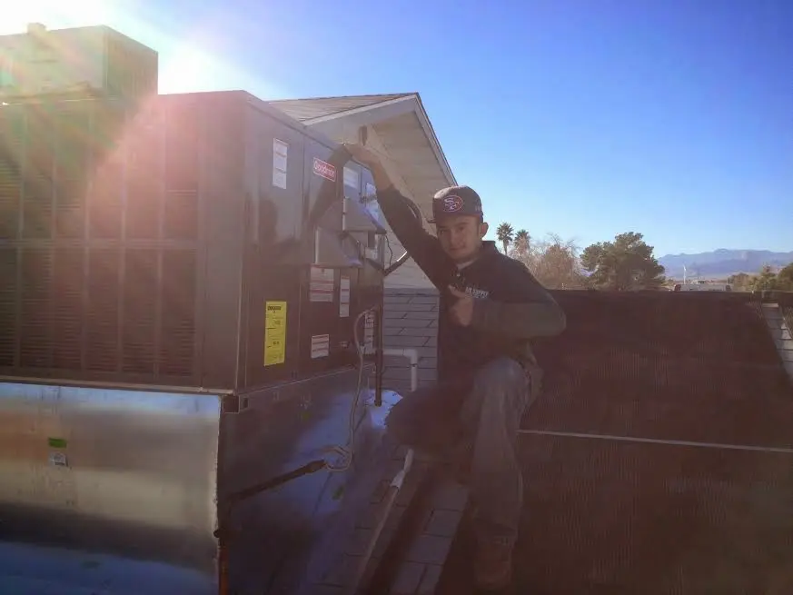 HVAC technician performing HVAC Inspection on a rooftop unit in Balch Springs